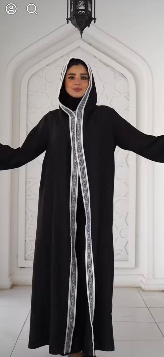 Black kaftan with thin Arabic trim and a hood. ✨