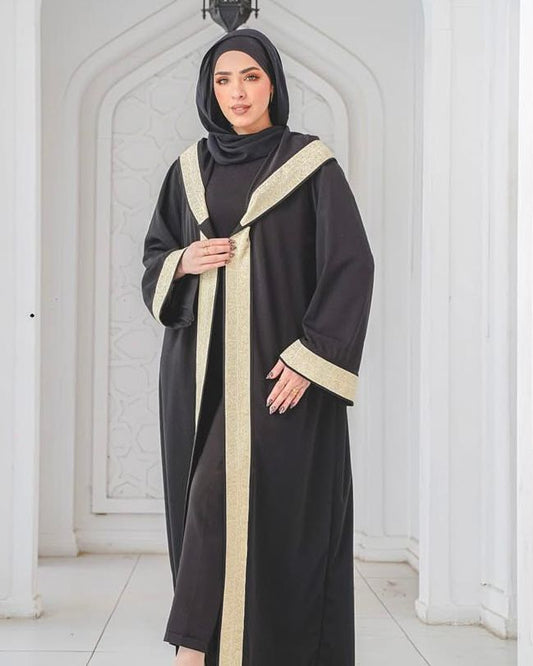 Black kaftan with wide gold trim and a hood. ✨