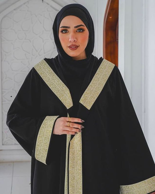 Black kaftan with wide gold trim and a hood. ✨