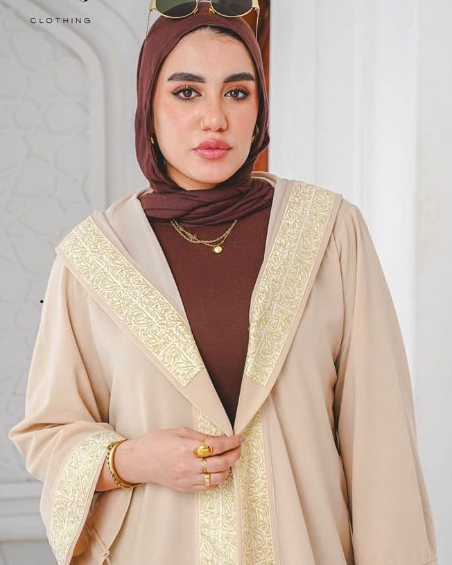Beige kaftan with wide gold trim and a hood. ✨